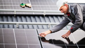 Solar engineer fixing solar panels to roof